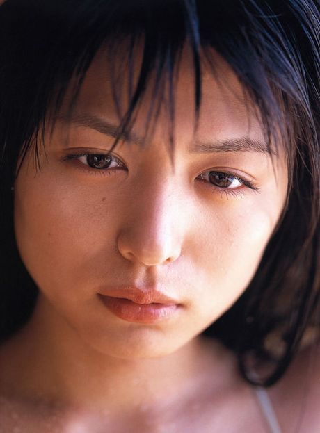 Petite cute little asian gravure model wearing an orange bikini