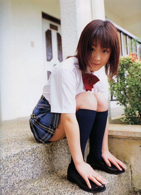 Alluring asian beauty with large full heavy breasts in a bikini