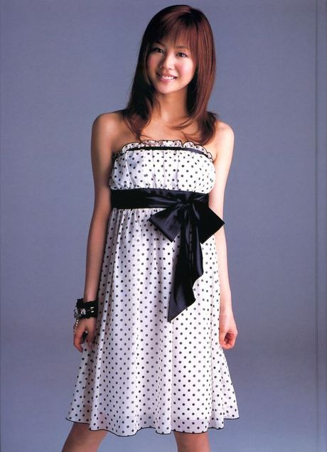 Cute asian girl is flirtatious with her long hair in a dress