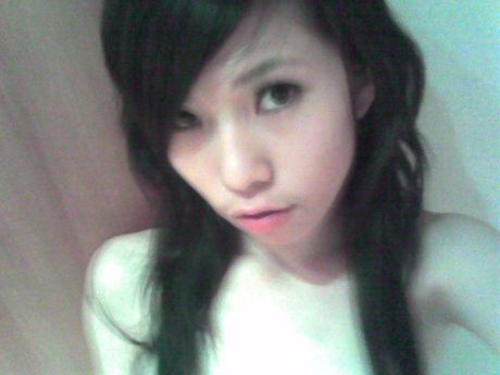 Two Asian girls posing nude in a hotel room