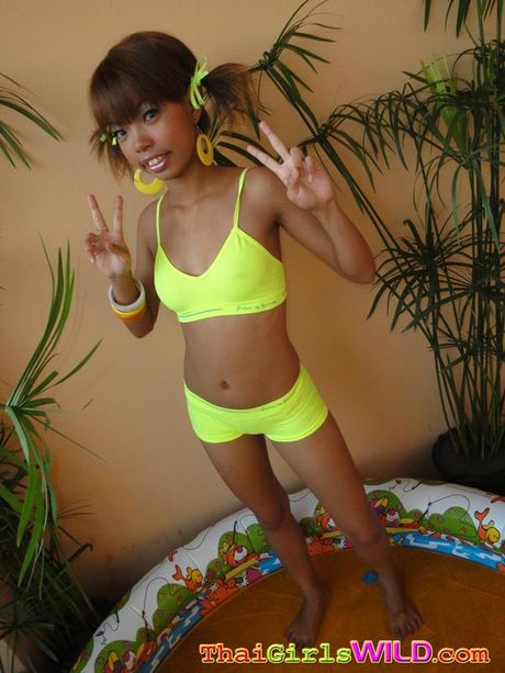 Petite Thai cutie takes pictures of herself posing in a blowup pool
