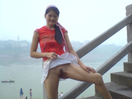 Asian amateur girl strips and shows her tiny tits and pussy in public