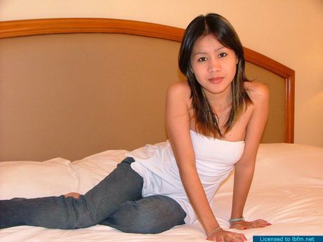 Adorable petite 18 year old bargirl naked on a big bed and showing pink