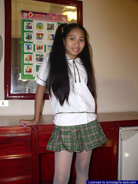 Long haired petite 18 yo  girl lifting her school skirt to show her privates