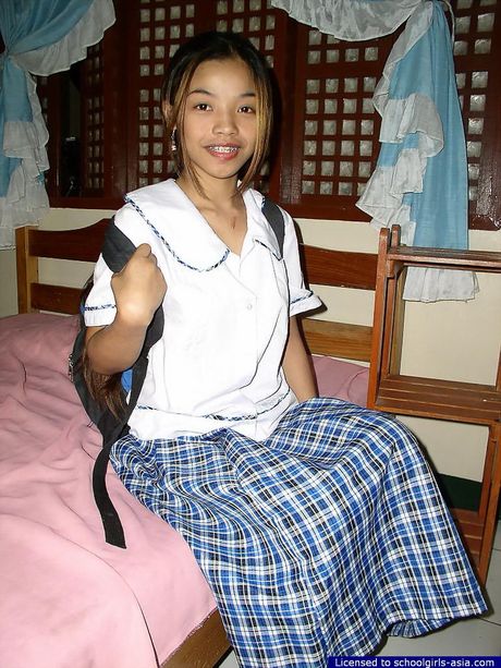 Cute and slim girl dropping her school uniform to play with her slit