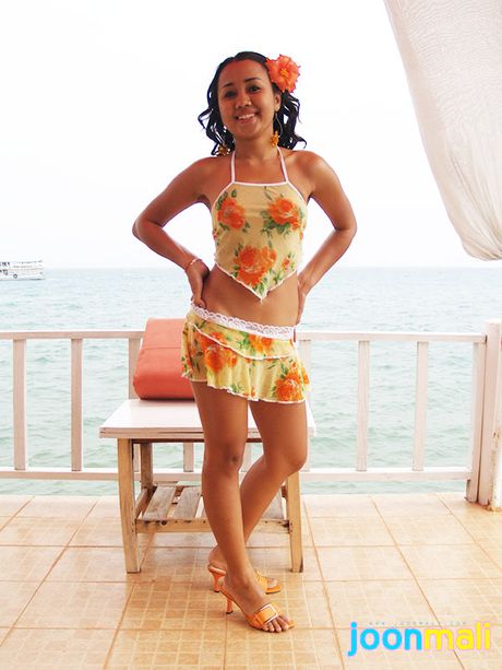 Topless tropical island teen shows her tanned brown buns