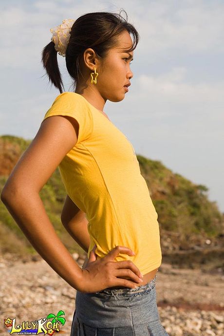 Cute Asian teen exposes perky titties and panties outside