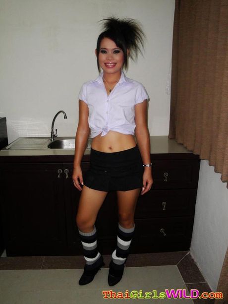 Hot Thai schoolgirl Nah strips then rides a hard white cock