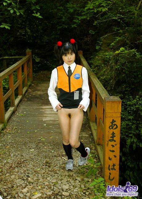 Asian slut in pigtails and uniform shows her hairy pussy and her favorite toys