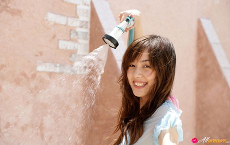 Rola Chen Asian plays with outdoor shower on body over lingerie