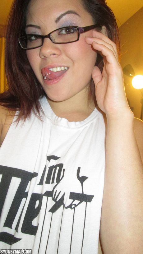 Asian amateur Sydney Mai shows her amazing racks and toys her pussy on a bed