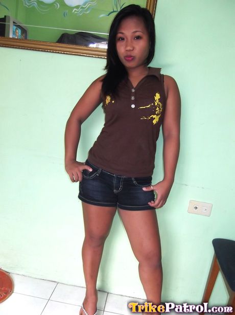 Asian babe Jo Ann strips and shows her tiny tits and shaved pussy