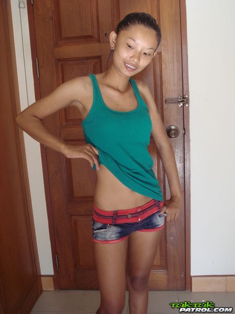 Skinny Asian teen Tik strips and shows her tiny tits and ass