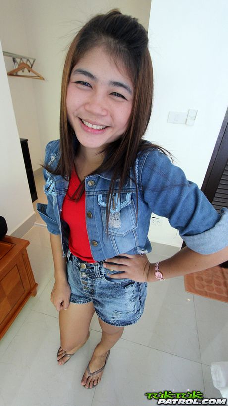 Asian teen Tan strips and shows her tiny tits and pink pussy up close