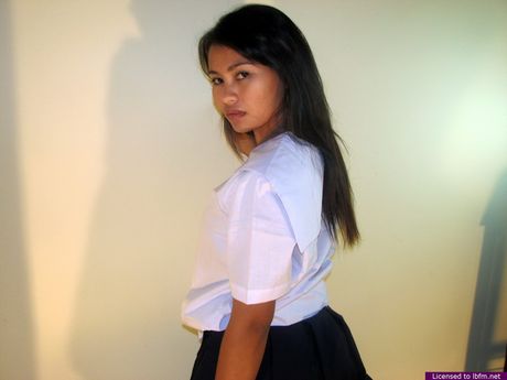 Skinny Asian schoolgirl strips off and unveils her tiny tits and pussy up close