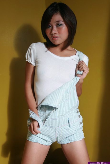 Japanese lady strips and bares her tiny tits and ass