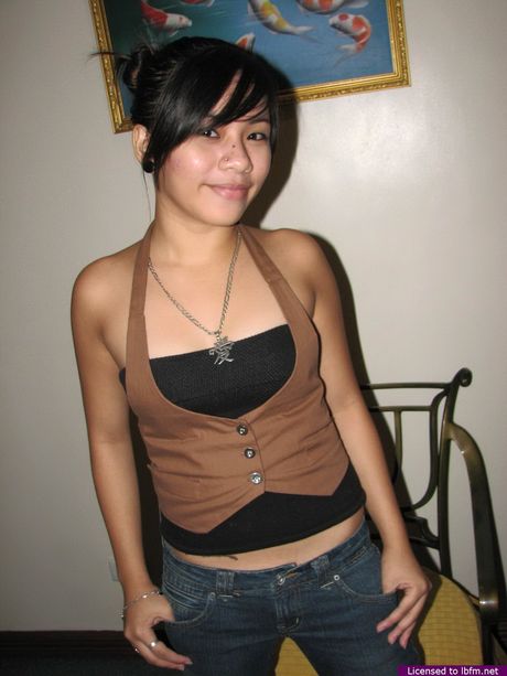 Asian teen with a tiny tattoo on her ass strips and displays her pierced nips