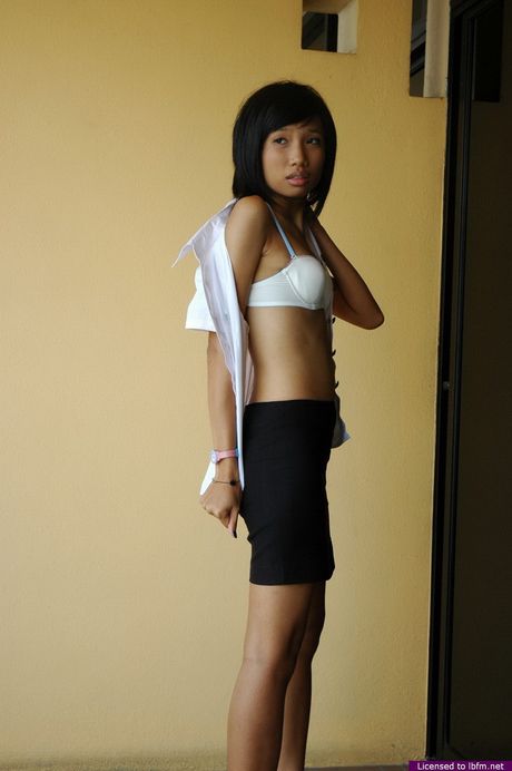 Skinny Japanese amateur chick strips and shows her tiny tits and pussy