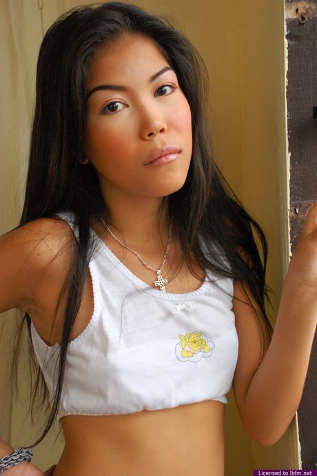 Skinny Asian amateur woman strips and unveils her tiny tits and ass