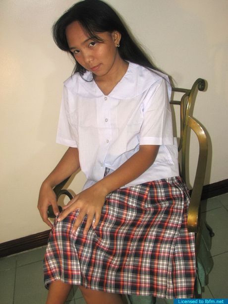 Asian schoolgirl amateur girl strips and bares her shaved pussy up close