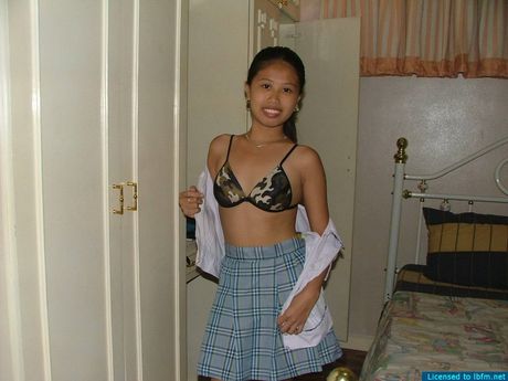 Asian schoolgirl amateur strips off and reveals her tiny tits and pussy