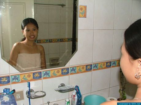 Asian amateur girl strips and takes a shower in the bathroom