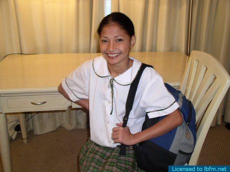 Amateur Asian schoolgirl strips and shows her shaved pussy up close