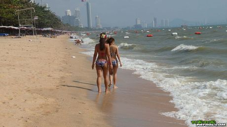 Asian teens Bee and Miaw flaunt their perfect bootyes and toys on the beach