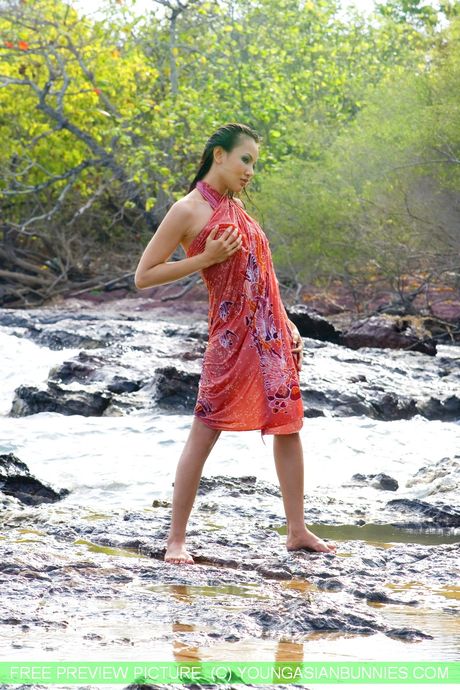 Asian teen Anya strips and shows her small tits and hot ass outdoors