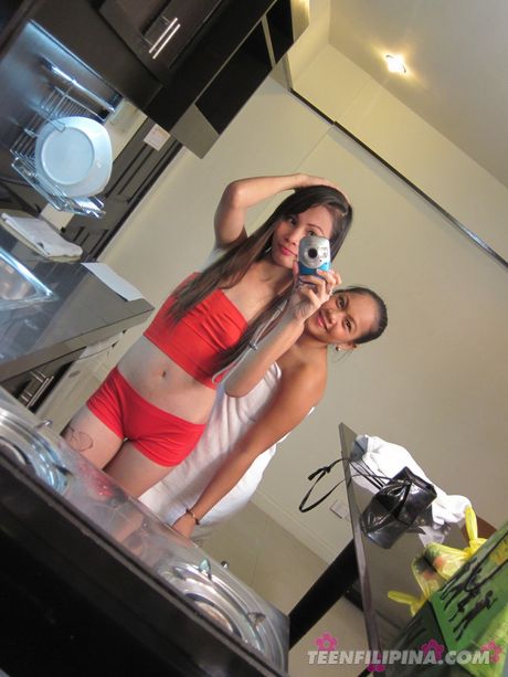 Japanese teen strips and shows her tiny tits and pussy in the kitchen