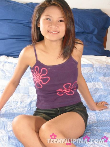 Amateur Asian girl toys her pussy with a dildo after stripping