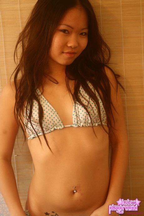 Asian teen Grace strips off her bikini and presents her big juggs and ass