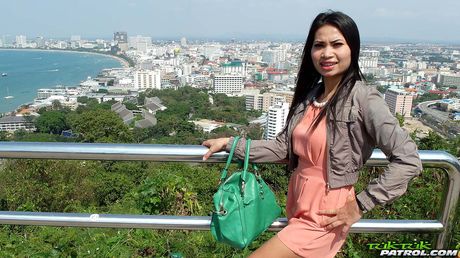 Asian teen Ping strips and shows her sexy booty and tits in a public place