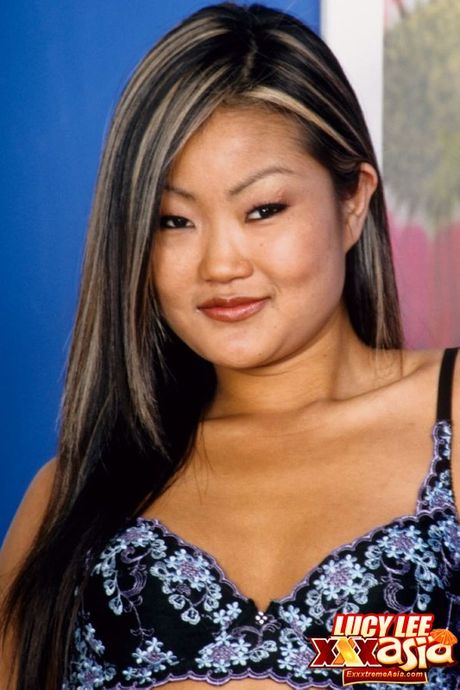 Asian babe Lucy Lee strips and fingers wet pussy after a hot striptease