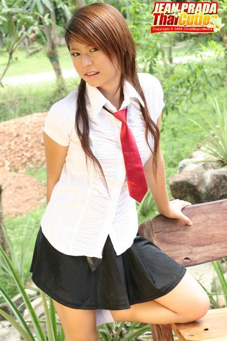 Stunning Asian schoolgirl Jean Prada strips and shows her tiny tits and ass