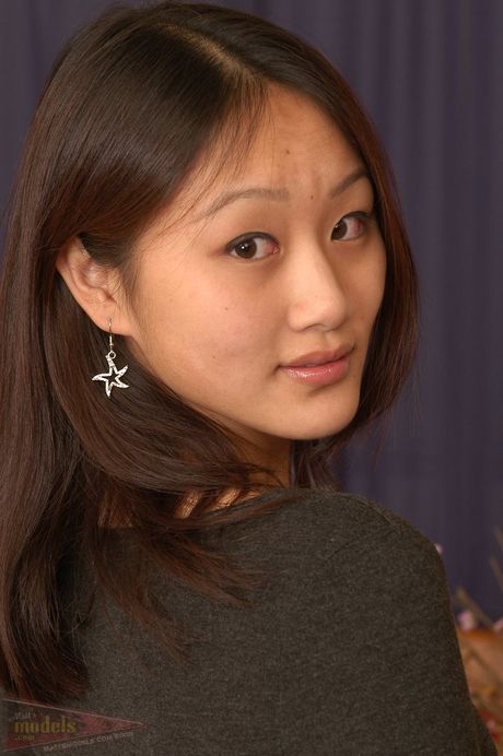 Asian teen Evelyn strips and shows her sexy butt and tits in a solo