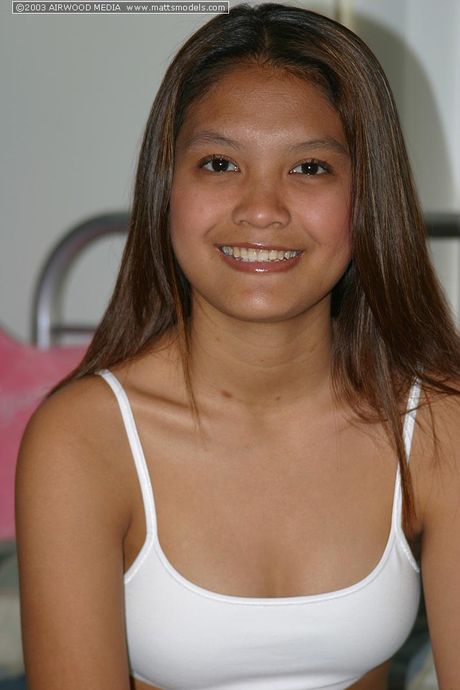 Asian teen Tai Angel strips and shows her tiny tits and pink pussy