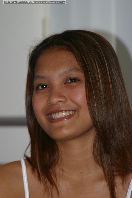 Asian teen Tai Angel strips and shows her hairy pussy up close