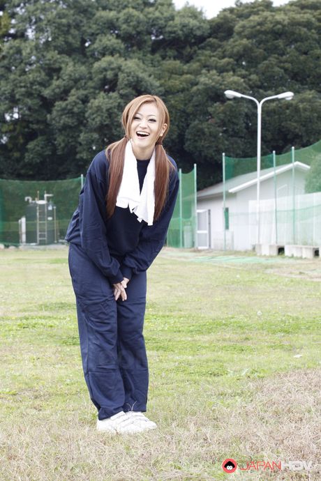 Hot and sensual babe An Umemiya stretches on football field and poses