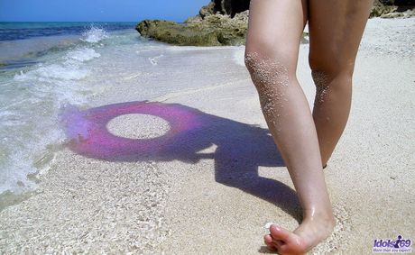 Platinum Japanese babe Nao Yoshizaki reveals her tiny tits and hot ass on the beach