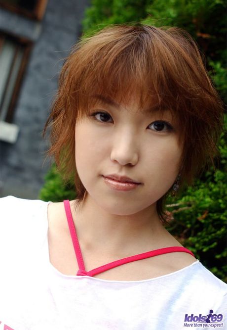 Sexy Japanese babe Madoka Ozava strips and shows her hairy pussy