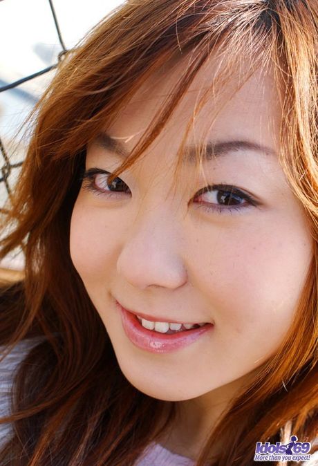 Asian babe Yumi strips and shows her hairy cunt in a solo