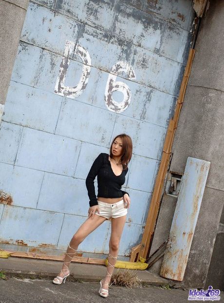 Hot Asian babe Sayumi strips and shows her hairy cunt in a solo