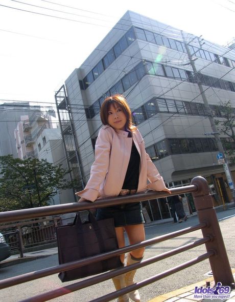 Superb Asian babe Tomomi toying her pussy with a dildo in a public place