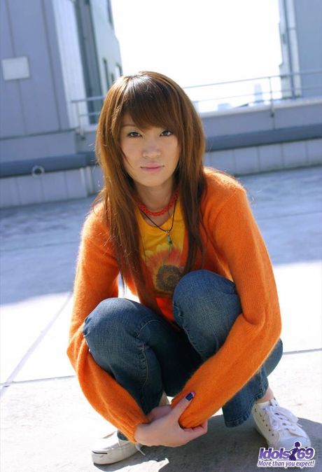 Sexy Japanese babe Chisato displays her slender body and hairy pussy in public