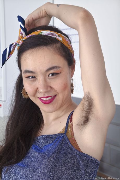 Amateur Asian Rylee Mae strips and shows her hairy pussy in the kitchen