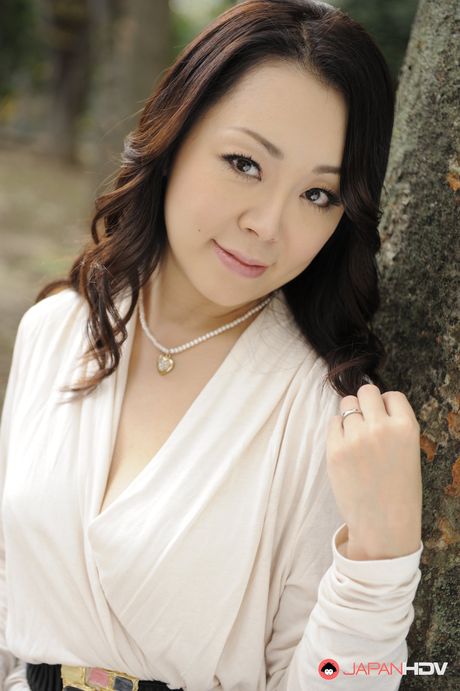 Asian Yuna Yamami in a white dress is very elegant and attractive.