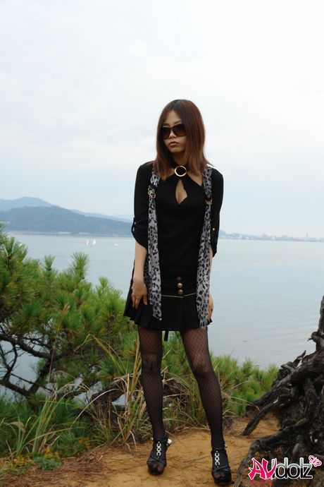 Asian babe Rena strips to her pantyhose and bares it all outdoors