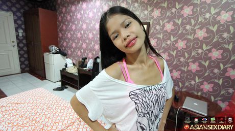 Skinny Asian teen Anabel strips and shows her hairy pussy up close