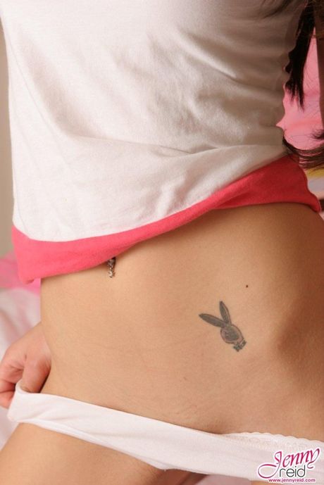 Sexy Asian teen Jenny Reid strips and unveils her pierced tits and ass